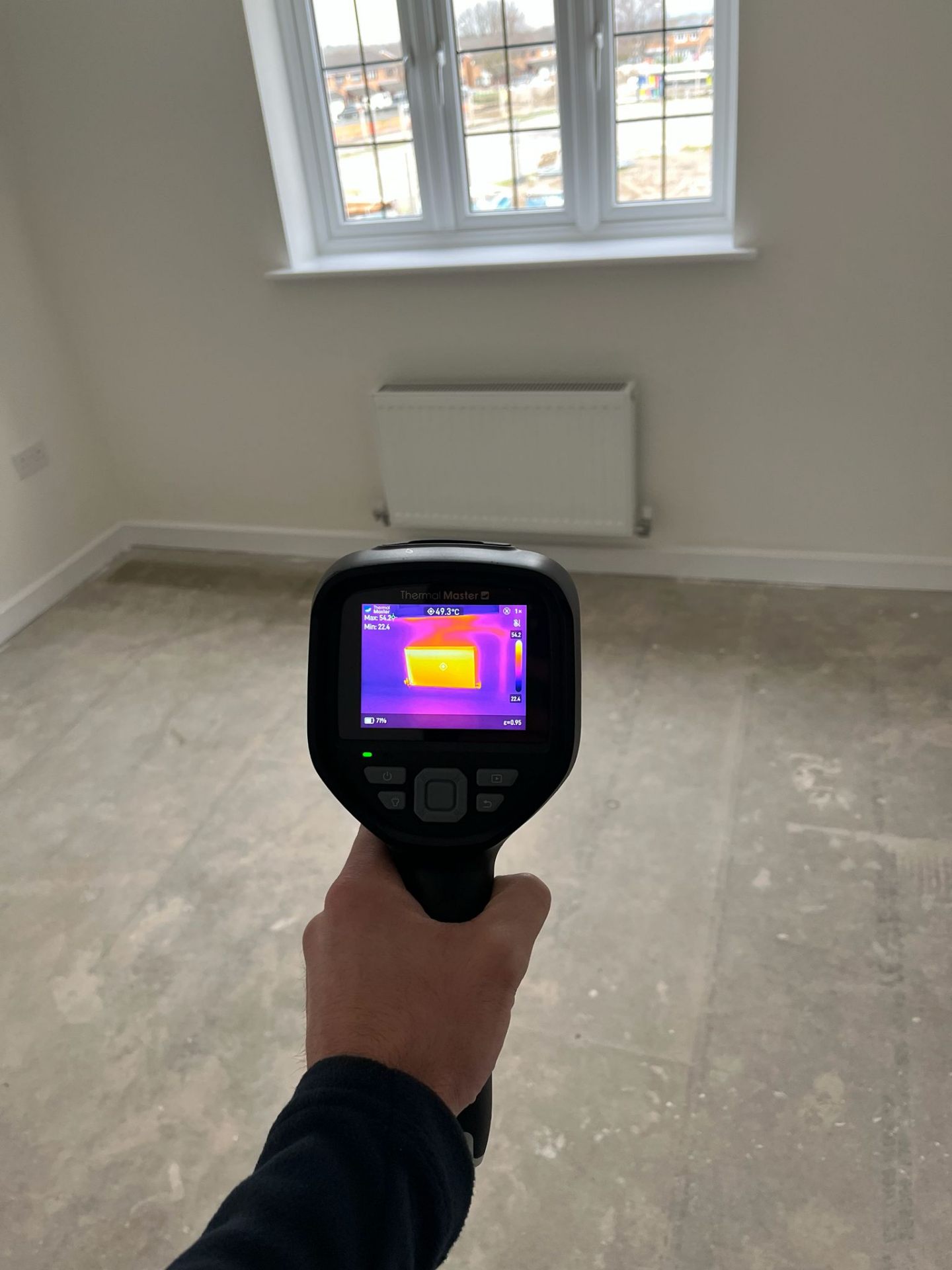 Thermal imaging camera showing heat distribution across a new build radiator